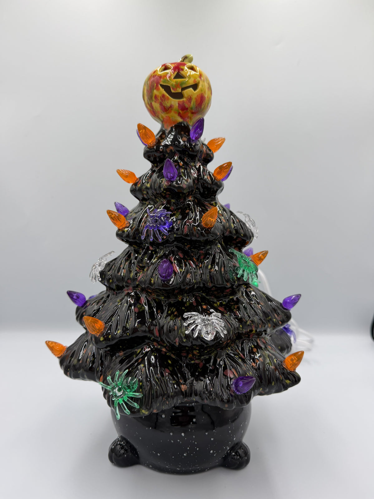 12 inch black ceramic Halloween tree with orange and purple bulbs, spiders, and jack-o'-lantern topper