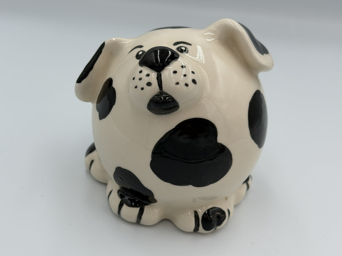 Round cream ceramic dog bank with black spots and floppy spotted ears