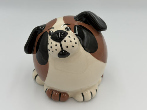 Round cream ceramic dog bank with brown and black patches and floppy black ears