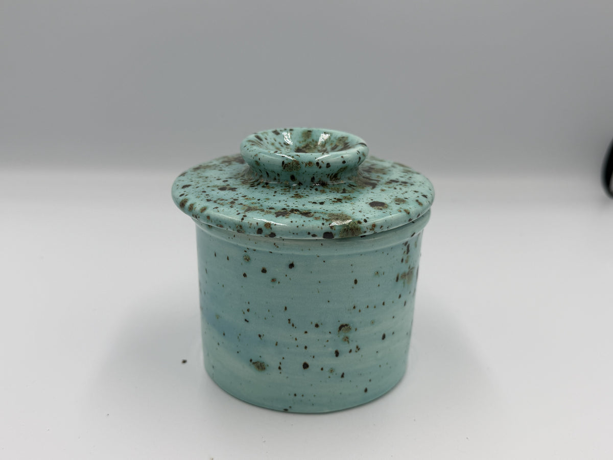 Turquoise speckled ceramic butter bell with lid closed