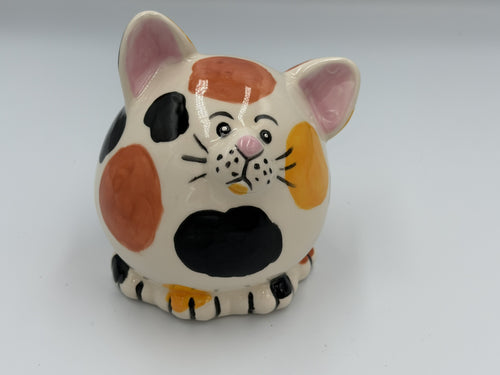 Round cream ceramic calico cat bank with orange, yellow, and black patches and pink ears