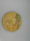 Yellow speckled ceramic pumpkin-shaped plate with sculpted green leaf, stem, and vine