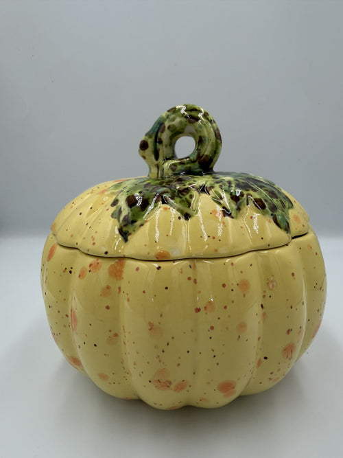 Yellow speckled ceramic harvest pumpkin with green leafy lid and curly stem