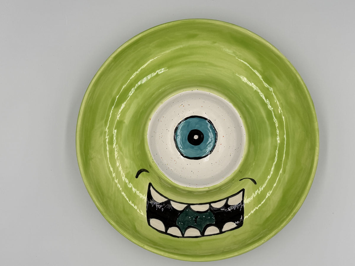 Lime green one-eyed monster ceramic chip and dip platter with toothy grin