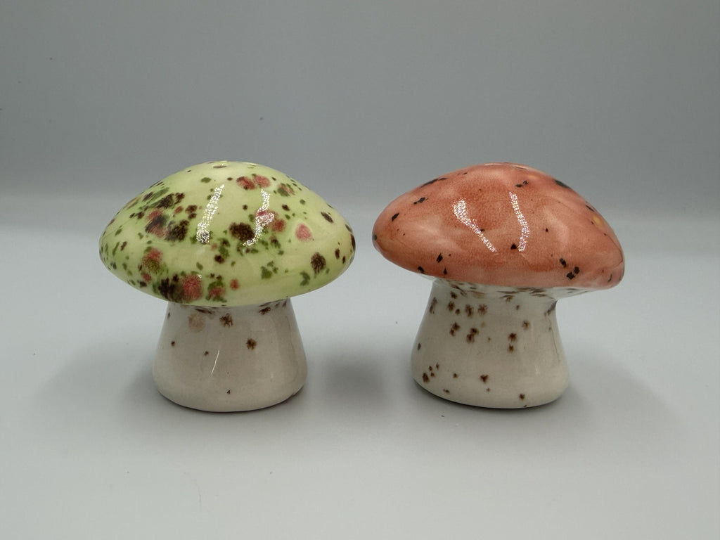 Green and salmon pink speckled ceramic mushroom salt and pepper shakers, side view