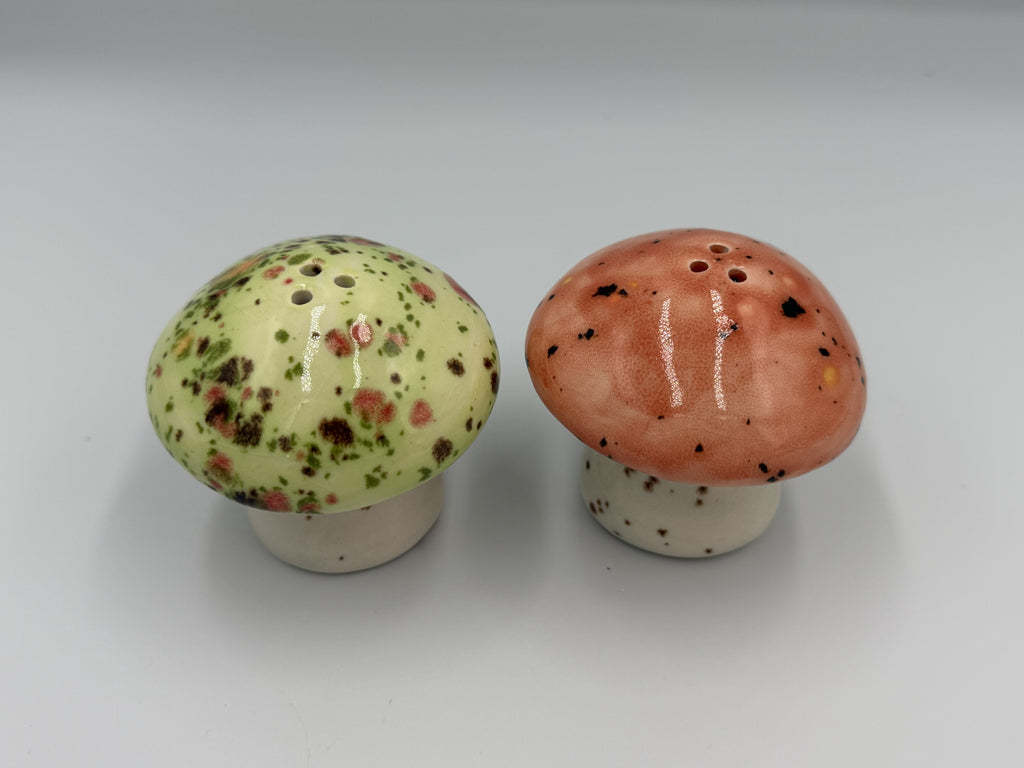 Top view of speckled ceramic mushroom salt and pepper shakers showing shaker holes