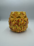 Yellow speckled ceramic lantern sculpted from autumn leaves with cut-out openings